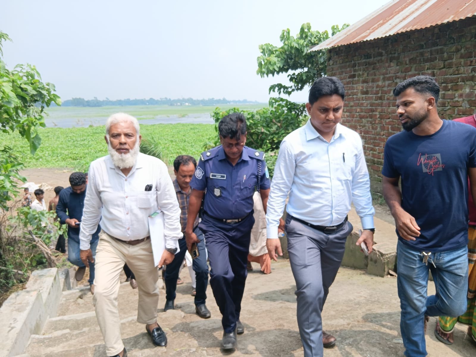 Officials walking field with police.